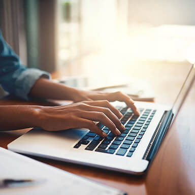 Woman typing at keyboard