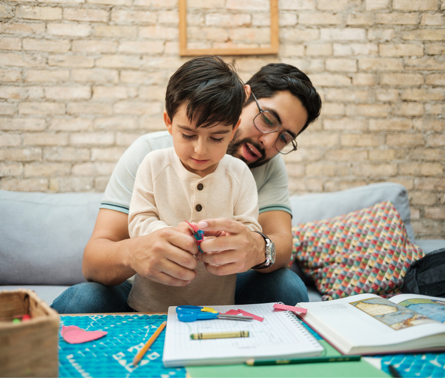 Father and young son coloring together